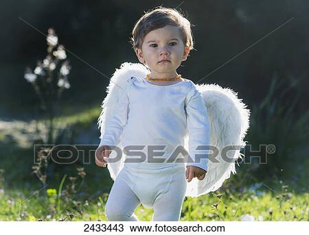 Stock Image - Happy baby with wings; Tarifa, Cadiz, Andalusia, Spain. Fotosearch