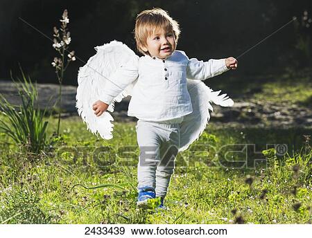 Stock Photo - Happy baby with wings; Tarifa, Cadiz, Andalusia, Spain. Fotosearch