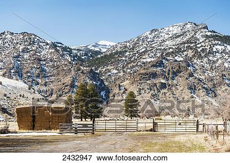 Stock Photo - Hay stack in front of the Warner Mountains, Modoc County; California, United States of America. Fotosearch