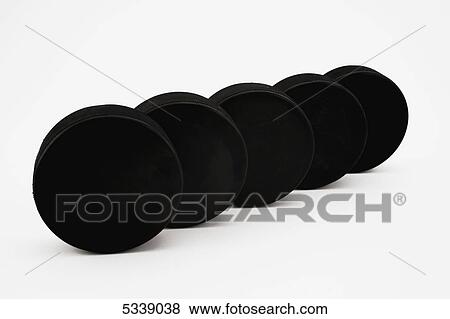 Stock Photo - Hockey pucks; Waterloo, Quebec, Canada. Fotosearch