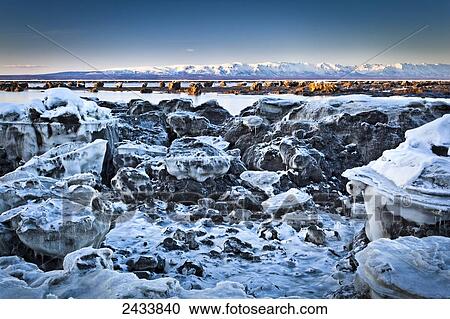 Stock Image - Icebergs at Knik Arm, with the Alaska range in the background; Chugiak, Alaska, United States of America. Fotosearch