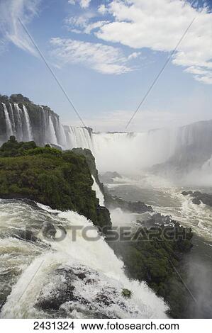 Iguacu Falls in Brazil in the foreground and Argentina seen beyond the river; Brazil View Large Photo Image Picture - Iguacu Falls in Brazil in the foreground and Argentina seen beyond the river; Brazil. Fotosearch