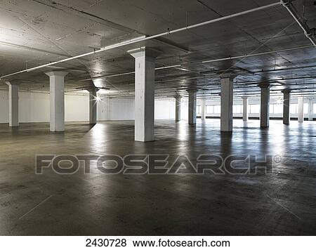 Stock Photo - Light reflected on the glossy surface of a cement floor in a condominium building; Montreal, Quebec, Canada. Fotosearch