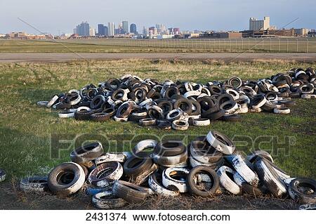 Picture - Loads of tires at Edmonton City Center Airport, with the Edmonton city skyline in the background; Edmonton, Alberta, Canada. Fotosearch