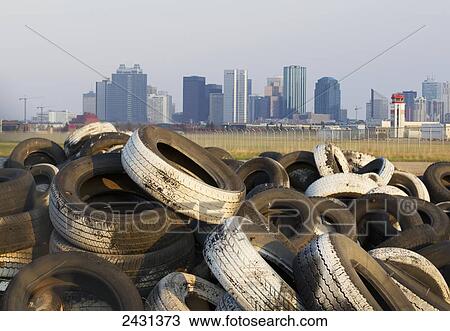 Stock Image - Loads of tires at Edmonton City Center Airport, with the Edmonton city skyline in the background; Edmonton, Alberta, Canada. Fotosearch