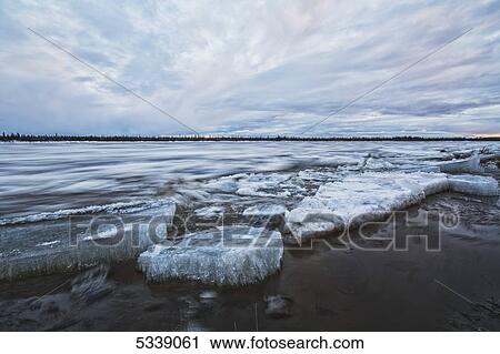 Stock Image - Long exposure of the ice flowing down the Porcupine River after it broke up; Old crow, Yukon, Canada. Fotosearch