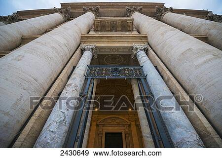 Low angle view of St. Peter's Basilica with large columns around a doorway; Rome, Lazio, Italy View Large Photo Image Stock Photo - Low angle view of St. Peter's Basilica with large columns around a doorway; Rome, Lazio, Italy. Fotosearch
