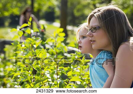 Mother and daughter watching intently at the park; Edmonton, Alberta, Canada View Large Photo Image Stock Photo - Mother and daughter watching intently at the park; Edmonton, Alberta, Canada. Fotosearch