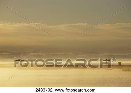 Stock Image - Northern Lake Baikal at dawn on a misty summer morning; Severobaikalsk, Buryatia, Siberia, Russia. Fotosearch