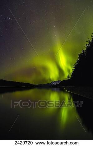 Stock Image - Northern Lights as seen from Echo Cove, Lions Head and Berners Bay in the distance, Tongas National Forest; Juneau, Alaska, United States of America. Fotosearch