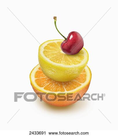 Stock Image - Pile of orange and lemon topped with a cherry. Fotosearch