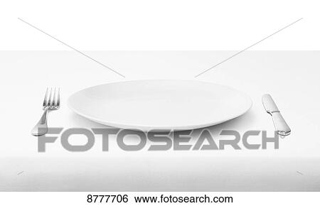 Stock Photograph - Place setting of white plate and utensils on white tablecloth. Fotosearch