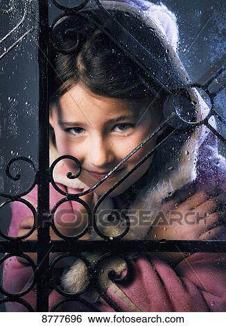 Portrait of a young girl looking through a window; Tarifa, Cadiz, Andalusia, Spain View Large Photo Image Stock Photograph - Portrait of a young girl looking through a window; Tarifa, Cadiz, Andalusia, Spain. Fotosearch