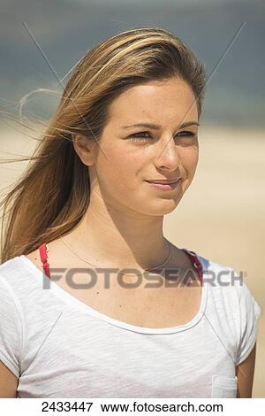 Stock Photo - Portrait of a young woman with long blond hair on the beach; Tarifa, Cadiz, Andalusia, Spain. Fotosearch