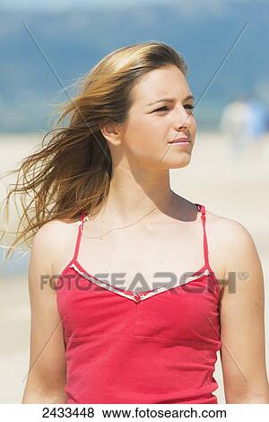 Portrait of a young woman with long blond hair on the beach; Tarifa, Cadiz, Andalusia, Spain View Large Photo Image Stock Photo - Portrait of a young woman with long blond hair on the beach; Tarifa, Cadiz, Andalusia, Spain. Fotosearch