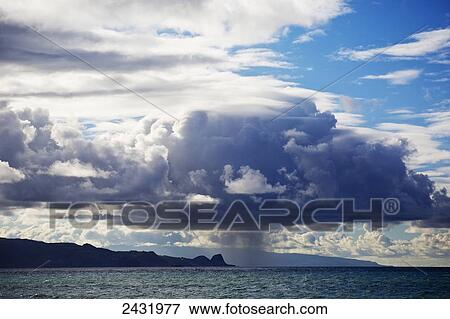 Stock Photo - Rain cloud dumping water over the north shore of Maui; Maui, Hawaii, United States of America. Fotosearch