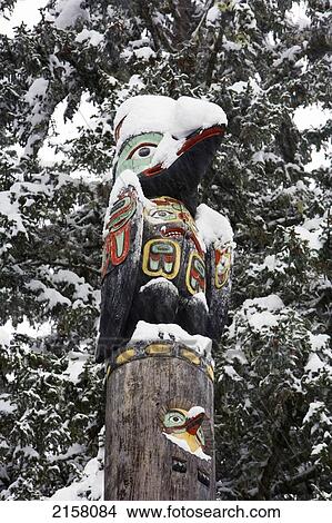 Picture - Raven Totemic Figure On Tlingit Totem Pole At Auke Bay Recreation Area. Winter In Southeast Alaska.. Fotosearch