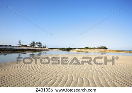 Stock Photography - Rippled sand on a beach at low tide; Vamizi Island, Mozambique. Fotosearch