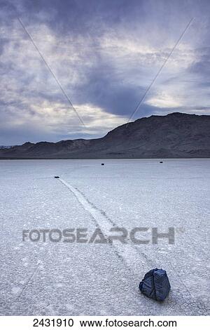 Stock Image - Rocks and dried lake bed at the Racetrack in Death Valley National Park; California, United States of America. Fotosearch