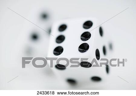 Stock Photo - Rolling dice. Fotosearch