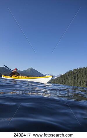 Stock Photo - Sea Kayaking on Auke Lake, Mt. McGinnis, Mendenhall Glacier and Mendenhall Towers beyond, Juneau. Alaska.. Fotosearch