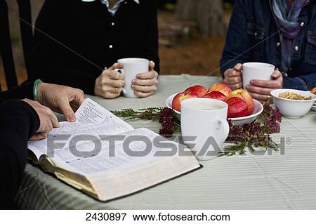 Sharing a cup of coffee and reading the Bible; Abbotsford, British Columbia, Canada View Large Photo Image Stock Photo - Sharing a cup of coffee and reading the Bible; Abbotsford, British Columbia, Canada. Fotosearch