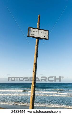 Sign on the beach for windsurfing and bathrooms; Tarifa, Cadiz, Andalusia, Spain View Large Photo Image Picture - Sign on the beach for windsurfing and bathrooms; Tarifa, Cadiz, Andalusia, Spain. Fotosearch