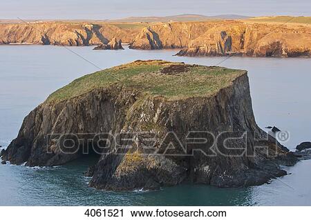 Small island and cliffs at sundown near Trefin village on the Pembrokeshire Coast Path; Wales View Large Photo Image Stock Image - Small island and cliffs at sundown near Trefin village on the Pembrokeshire Coast Path; Wales. Fotosearch