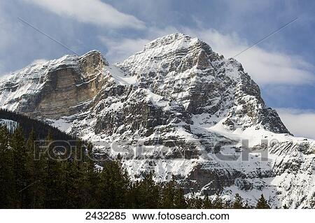 Snow covered mountain peak with blue sky and clouds; Field, British Columbia, Canada View Large Photo Image Stock Photography - Snow covered mountain peak with blue sky and clouds; Field, British Columbia, Canada. Fotosearch