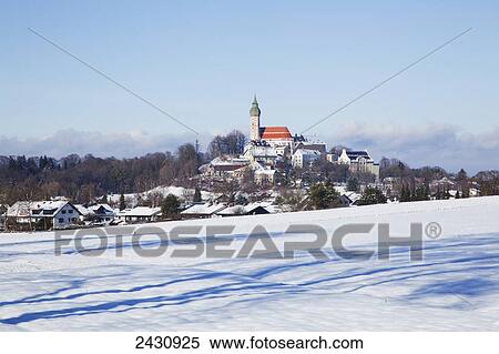 Stock Photography - Snowy field and Andechs Abbey in the distance; Herrsching, Bavaria, Germany. Fotosearch