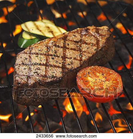 Stock Photograph - Steak on the grill. Fotosearch