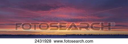 Stock Photo - Sunrise clouds over the Porcupine River; Old Crow, Yukon, Canada. Fotosearch