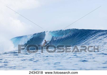 Surfer riding perfect waves in the South Pacific; Tahiti, French Polynesia View Large Photo Image Stock Photo - Surfer riding perfect waves in the South Pacific; Tahiti, French Polynesia. Fotosearch