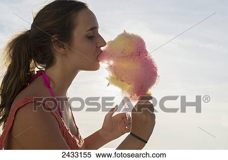 Teenage girl eating candy floss; England View Large Photo Image Stock Photography - Teenage girl eating candy floss; England. Fotosearch