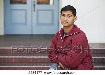 Stock Photo - Teenaged boy standing in front of a public building; San Francisco, California, United States of America. Fotosearch