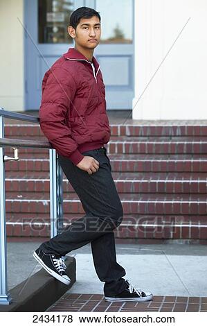 Teenaged boy standing in front of a public building; San Francisco, California, United States of America View Large Photo Image Stock Photo - Teenaged boy standing in front of a public building; San Francisco, California, United States of America. Fotosearch