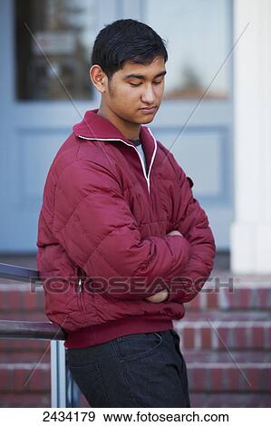 Teenaged boy standing in front of a public building; San Francisco, California, United States of America View Large Photo Image Stock Photo - Teenaged boy standing in front of a public building; San Francisco, California, United States of America. Fotosearch