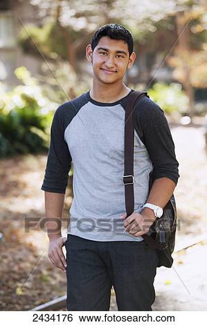 Teenaged boy walking with a book bag; San Francisco, California, United States of America View Large Photo Image Stock Photograph - Teenaged boy walking with a book bag; San Francisco, California, United States of America. Fotosearch