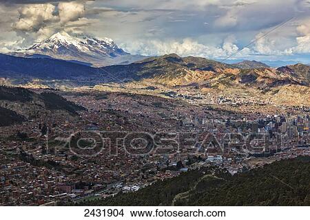 Picture - The city of La Paz with Illimani rising in the distance, the highest peak in Bolivia; La Paz, Bolivia. Fotosearch