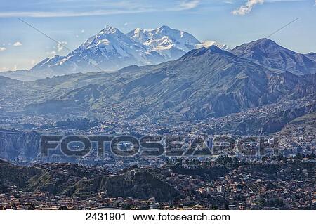 Stock Image - The mountain Illimani rises above the skyline of La Paz; La Paz, Bolivia. Fotosearch