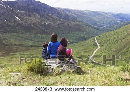 Stock Image - Three children enjoying view at Hatchers Pass; Palmer, Alaska, United States of America. Fotosearch