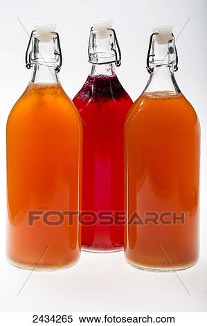 Three glass bottles with plastic stoppers with colourful fermented fruit juice on white background; Calgary, Alberta, Canada View Large Photo Image Stock Photography - Three glass bottles with plastic stoppers with colourful fermented fruit juice on white background; Calgary, Alberta, Canada. Fotosearch