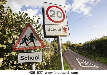 Stock Photo - Traffic sign to reduce the speed limit on this country lane near a school, Horsington village, South Somerset; Somerset, England. Fotosearch
