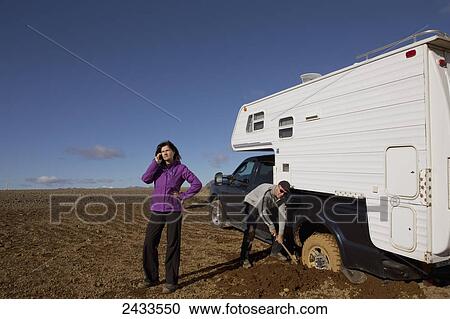 Truck stuck in the mud, woman calling for help on cell phone; Iceland View Large Photo Image Stock Image - Truck stuck in the mud, woman calling for help on cell phone; Iceland. Fotosearch