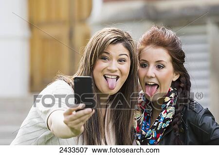 Two friends doing self-portrait to the camera; Edmonton, Alberta, Canada View Large Photo Image Stock Photo - Two friends doing self-portrait to the camera; Edmonton, Alberta, Canada. Fotosearch