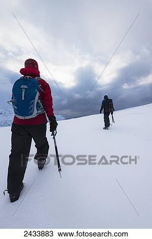 Two people walking in snow covered, winter conditions on Beinn an Dothaidh, near Bridge of Orchy; Argyll and Bute, Scotland View Large Photo Image Stock Image - Two people walking in snow covered, winter conditions on Beinn an Dothaidh, near Bridge of Orchy; Argyll and Bute, Scotland. Fotosearch