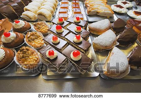 Stock Photo - Variety of desserts on trays; Tarifa, Cadiz, Andalusia, Spain. Fotosearch