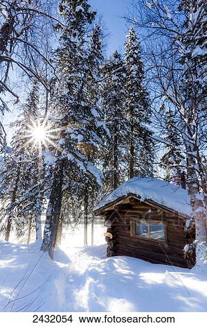 View of a public use log cabin at Byers Lake in fresh snow under a sun burst, Interior Alaska; Alaska, United States of America View Large Photo Image Picture - View of a public use log cabin at Byers Lake in fresh snow under a sun burst, Interior Alaska; Alaska, United States of America. Fotosearch
