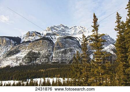 Stock Photograph - View Of Rocky Mountains in winter, near Banff; Alberta, Canada. Fotosearch