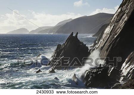 Stock Image - Waves crashing against the rugged coastline of the Blasket Islands, Dingle Peninsula; County Kerry, Ireland. Fotosearch
